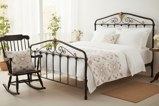White wicker swing with floral blanket and pillow on a porch