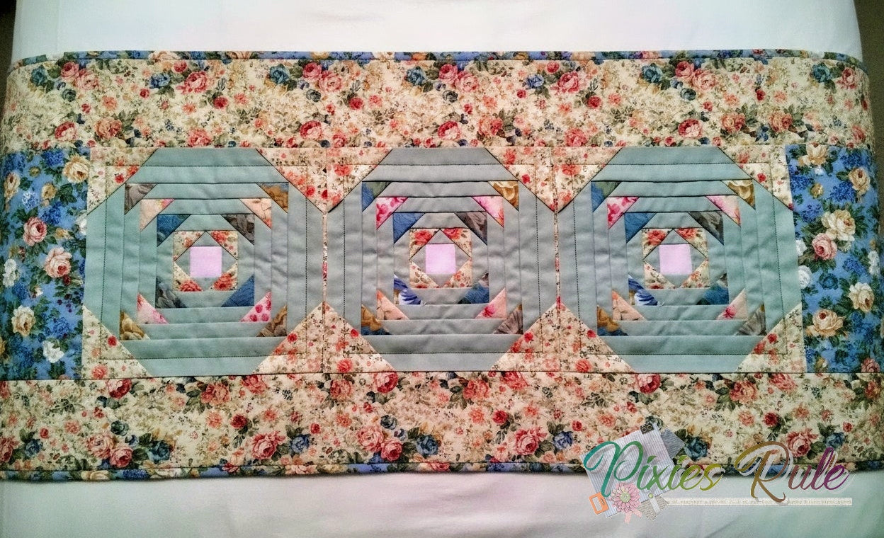 Quilted bedrunner with geometric pattern on flower splashed background.