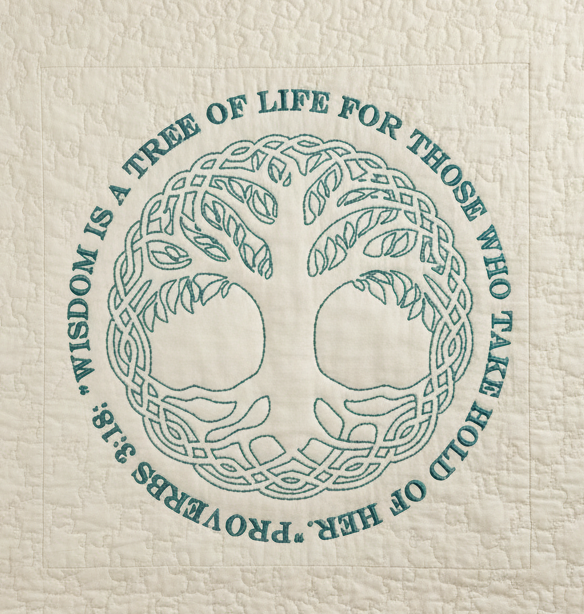 Textile with a tree of life design and text on a white background