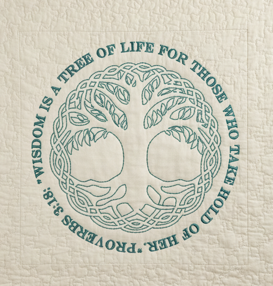 Textile with a tree of life design and text on a white background